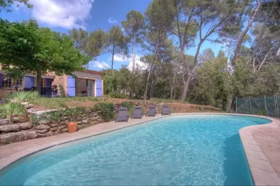 a swimming pool with chairs and a house at Villa Martine, authentic family home in Rognes