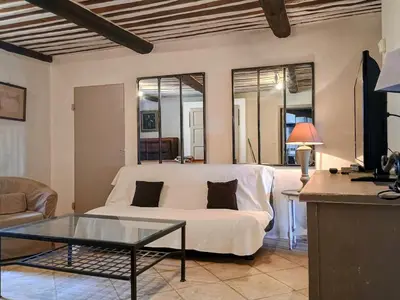 a living room with a white couch and a table at Gîte Sorgue - Exceptionnel 125 m2 Piscine Parking Jardin in Saumane-de-Vaucluse