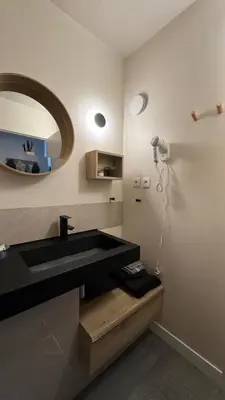 a bathroom with a black sink and a mirror at Greens View golf saumane in Saumane-de-Vaucluse