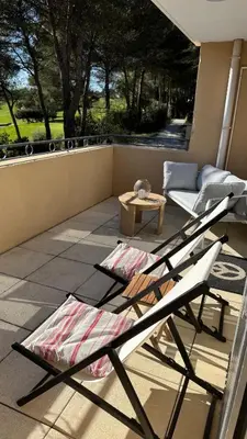 a patio with two lounge chairs and a table at Greens View golf saumane in Saumane-de-Vaucluse