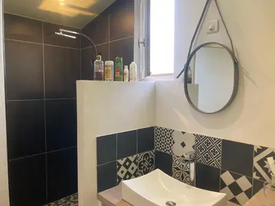 a bathroom with a sink and a mirror at 15 rue des pierres seches in Ferrassières