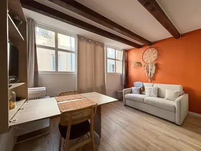 a living room with a table and a couch at Studio lumineux centre Aix en Provence in Aix-en-Provence