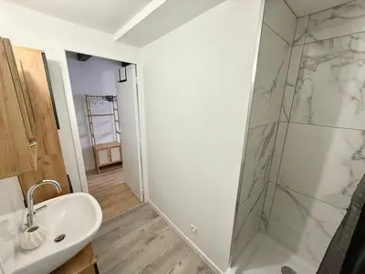 a bathroom with a sink and a glass shower at Studio lumineux centre Aix en Provence in Aix-en-Provence