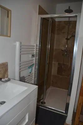 a shower with a glass door in a bathroom at Maison en coeur de ville in LʼIsle-sur-la-Sorgue