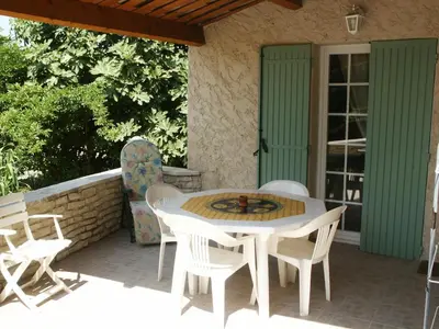 a white table and chairs on a patio at Pavillondulantana in Les Taillades