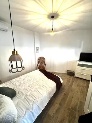 a bedroom with a large white bed and a ceiling at Élégant T2 proche gare et centre in Miramas