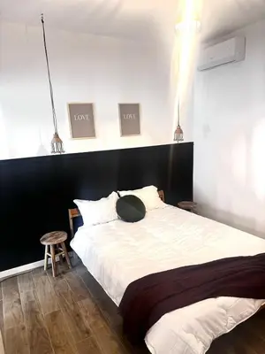 a bedroom with a large bed with a black headboard at Élégant T2 proche gare et centre in Miramas