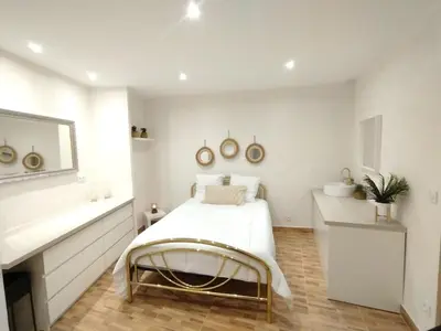 a white bedroom with a bed and a mirror at Charmant Appartement en Provence in Caromb