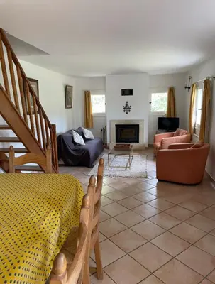 a living room with a bed and a fireplace at Domaine au cœur du Colorado Provençal in Gignac