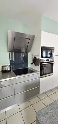 a kitchen with a stove and a microwave at Manava in Cheval-Blanc
