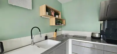 a kitchen with a sink and a microwave at Manava in Cheval-Blanc