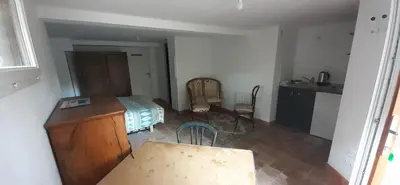a bedroom with a bed and a table and chairs at Studio indépendant au calme proche d'Aix en Provence in Aix-en-Provence