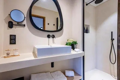 a bathroom with a sink and a mirror at La Villa des Cedres in Bonnieux