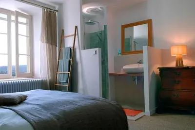 a bedroom with a bed and a sink and a mirror at Authentique mas provençal avec piscine in Beaumont-de-Pertuis