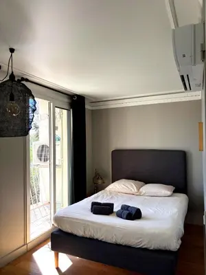 a living room with a couch and a table at Paul Cézanne garden apartment with air conditioning in Aix-en-Provence