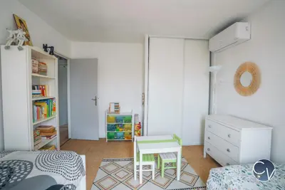 a bedroom with a bed and a table and a desk at Maison entière à 300m du centre in LʼIsle-sur-la-Sorgue