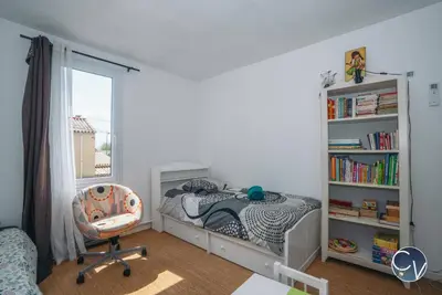 a bedroom with a bed and a book shelf at Maison entière à 300m du centre in LʼIsle-sur-la-Sorgue