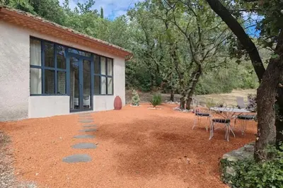a patio with a table and chairs in front of a house at The Rose Garden - Pernes-les-Fontaines in Pernes-les-Fontaines