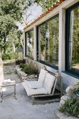 a white couch sitting on the porch of a house at The Aviary - Pernes-les-Fontaines in Pernes-les-Fontaines