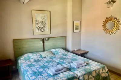 a bedroom with a bed with towels on it at La Maison Rose in LʼIsle-sur-la-Sorgue