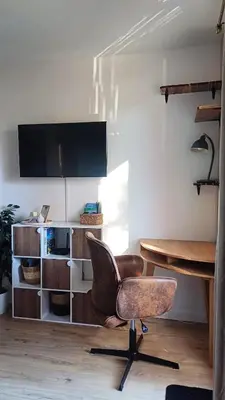 an office with a desk and a chair and a television at Le Colibri - studio paisible et raffiné au sud d'Aix in Aix-en-Provence