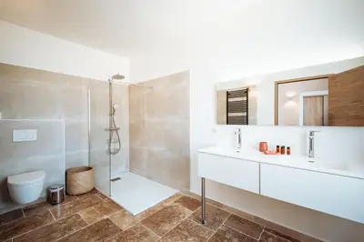 a bathroom with a shower and a sink and a toilet at La Source Blanche in Gargas