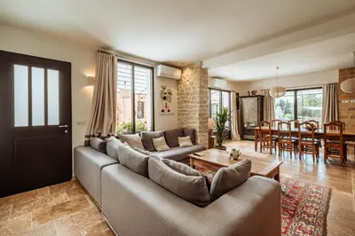 a living room with a couch and a table at La Source Blanche in Gargas
