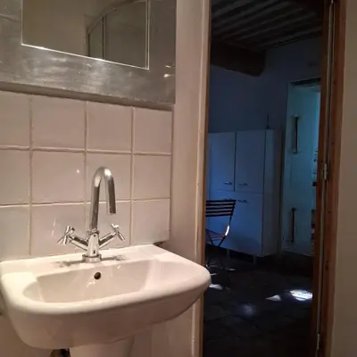 a bathroom with a sink and a mirror at gîtes carita in Cabannes