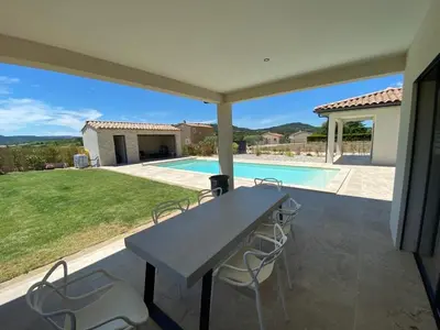 a patio with a table and chairs and a swimming pool at Villa with pool in Provence bij de Mont Ventoux in Blauvac