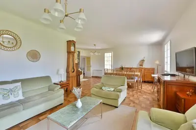 a living room with a couch and a table at Villa Marie-Rose in Saint-Didier