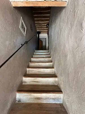 a stairway with wooden steps in a building at Mas Bourbon in Cavaillon