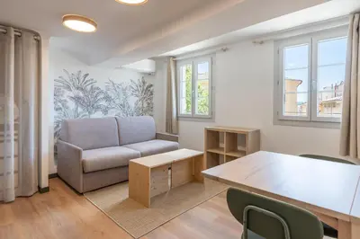 a living room with a couch and a table at Studio climatisé plein centre 4eme étage in Aix-en-Provence