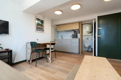 a kitchen and dining room with a table and chairs at Studio climatisé plein centre 4eme étage in Aix-en-Provence