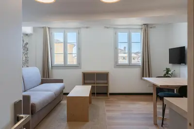 a living room with a couch and a table at Studio climatisé plein centre 4eme étage in Aix-en-Provence