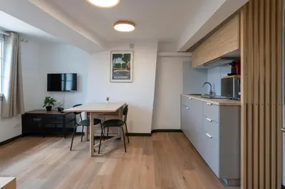 a kitchen and dining room with a table and chairs at Studio climatisé plein centre 4eme étage in Aix-en-Provence