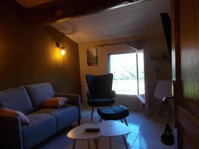 a living room with a couch and a chair at alize gîte en Provence in Jonquerettes