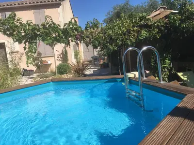 a swimming pool with a slide in the middle at alize gîte en Provence in Jonquerettes
