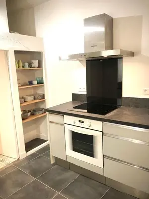 a kitchen with a stove and a stove top oven at Appart de charme CLIM 37m2 T1 Hôtel de ville in Aix-en-Provence