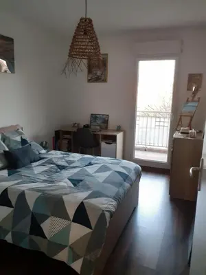 a bedroom with a bed and a desk and a window at Bichette in Cavaillon