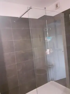 a shower with a glass door in a bathroom at Bichette in Cavaillon