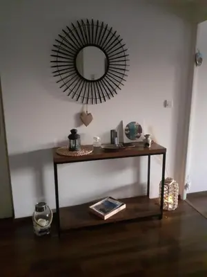 a mirror on a wall above a table with a mirror at Bichette in Cavaillon