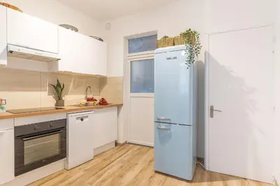 a kitchen with a refrigerator and a window at T3 proche cardeurs clim centre ville in Aix-en-Provence