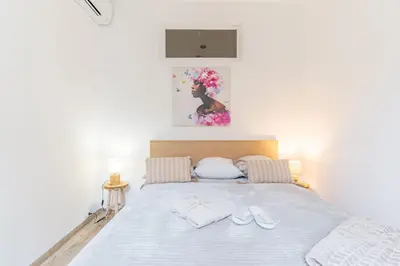 a bedroom with a bed with two slippers on it at T3 proche cardeurs clim centre ville in Aix-en-Provence