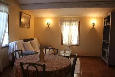a living room with a table and a couch at Gîte une treille en provence in Saint-Didier