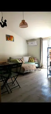a living room with a couch and a table at Ty'ca house in Velleron