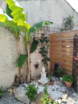 a garden in front of a house with a statue at Ty'ca house in Velleron
