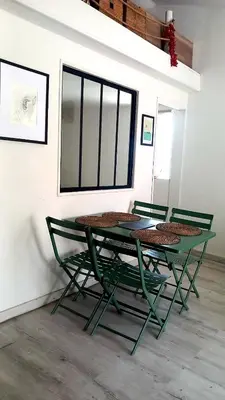 two green chairs and a table in a room at Ty'ca house in Velleron