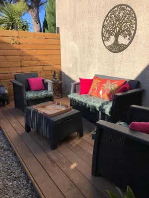 a patio with two couches and a coffee table at Ty'ca house in Velleron