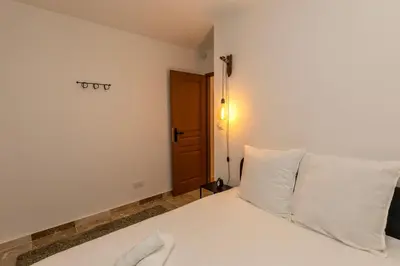 a bedroom with a bed with white sheets and pillows at Suite Terre d'Ocre - Hypercentre - Wifi in Apt