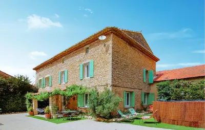 a large brick building with green shutters on it at Amazing Home In Lagnes in Lagnes